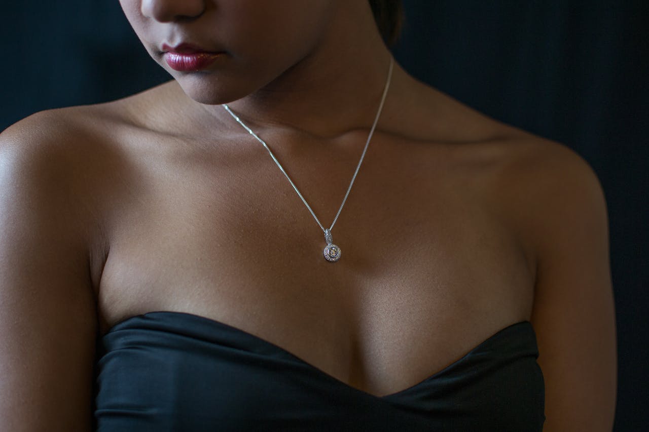gallery-2 Close-up portrait of a woman wearing a diamond necklace and black dress, embodying elegance and style.