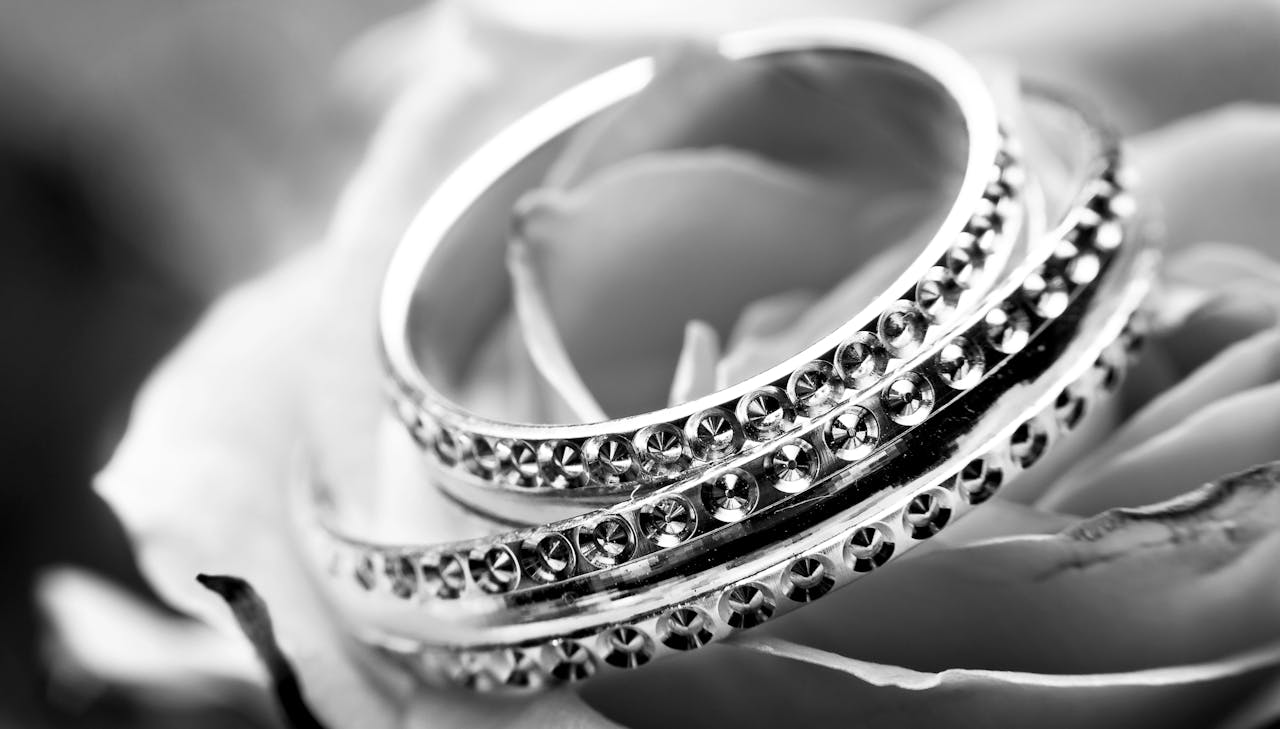 services-04 A detailed black and white image featuring ornate rings on a delicate rose, symbolizing elegance and romance.